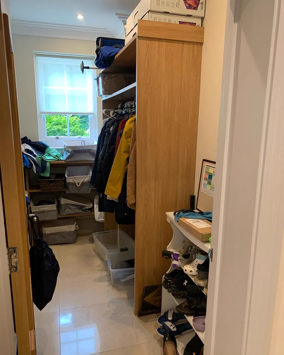 Boot room before: baskets and coats in a jumble