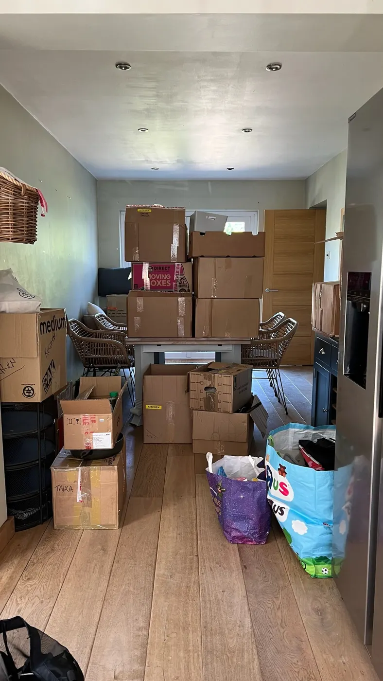 Dining room with moving boxes waiting to be unpacked