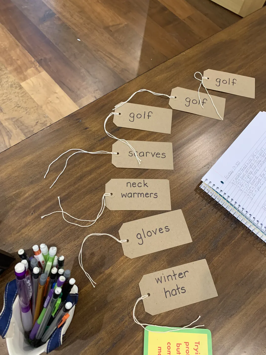 Handwritten brown tags for golf, scarves, gloves and winter hats