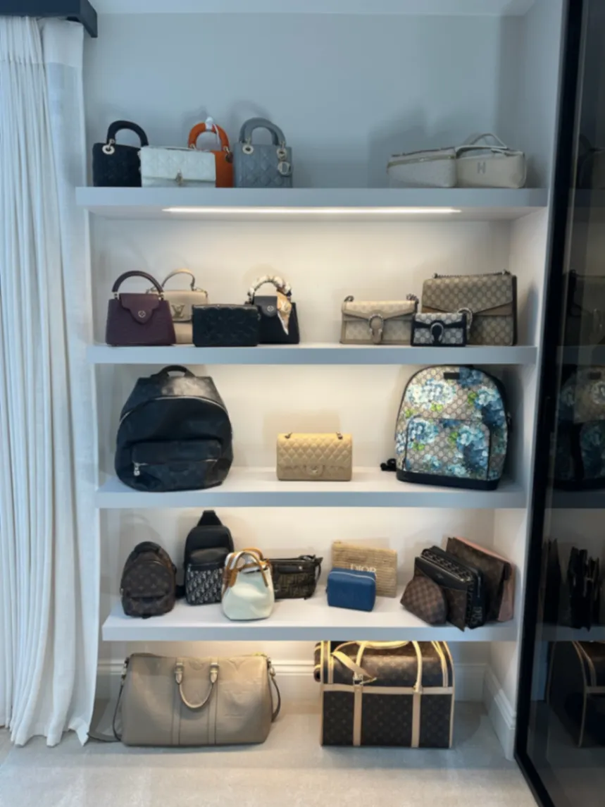 Handbags arranged individually on dressing room shelves
