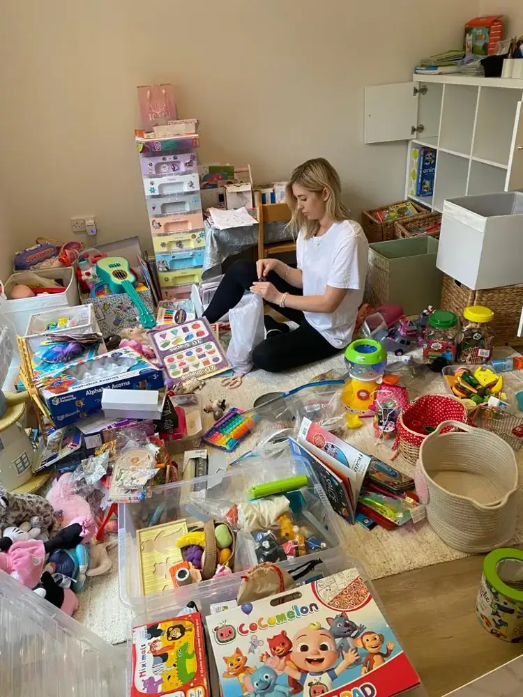 During decluttering: Ruth sorting playroom toys and boxes into categories