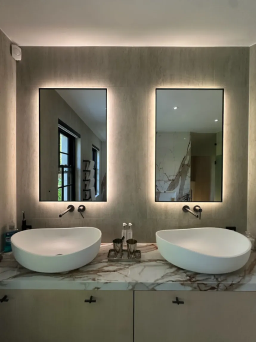 Bathroom vanity with twin basins and clear surfaces