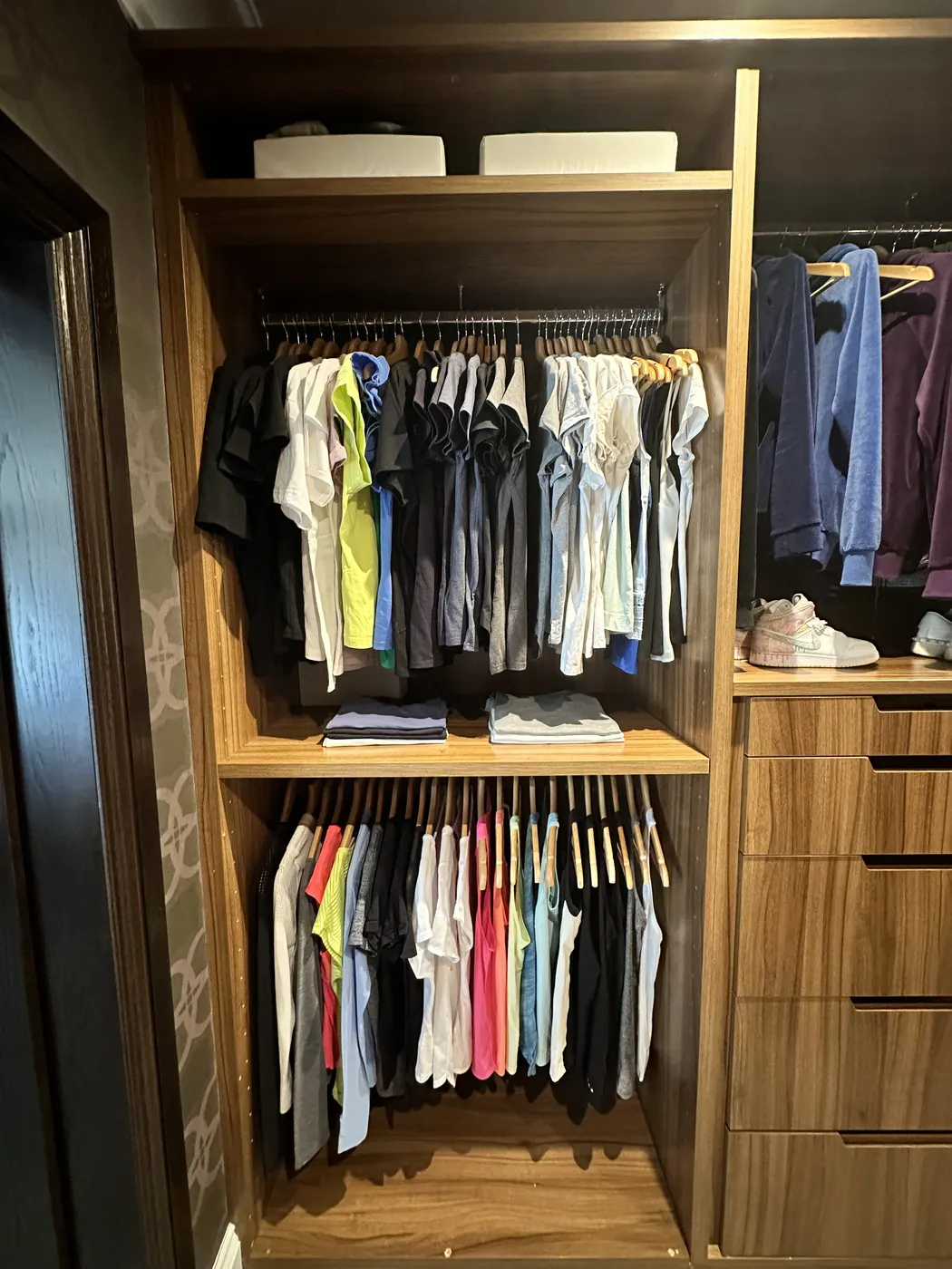 Wardrobe with shirts hung by colour and drawers below