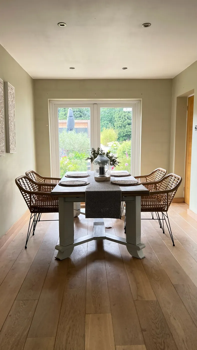 Same dining room after unpacking, with a clear floor and set table